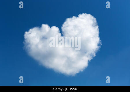 Heart shaped clouds on blue sky background Stock Photo
