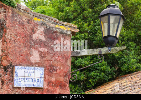 Street sign and lamp in Colonia del Sacramento, Uruguay. It is one of the oldest towns in Uruguay Stock Photo