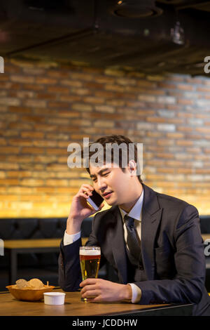 Portrait of single man talking on cellphone frowning face Stock Photo