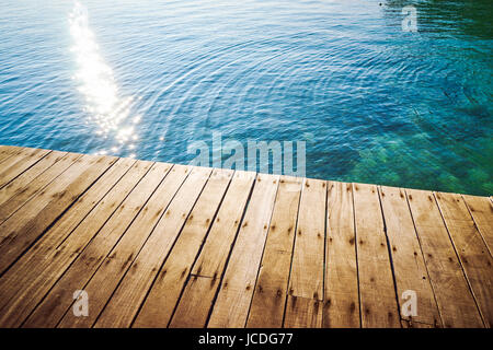 Wooden jetty with crystal clear and turquoise sea water of the tropical sea . Aerial top view .Rawa island , Malaysia . Stock Photo