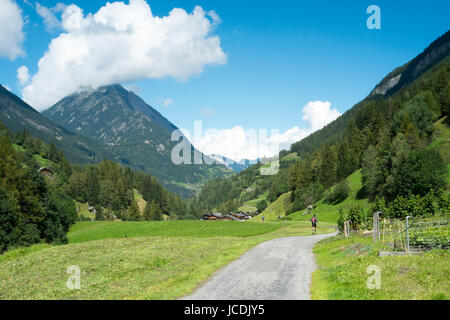 PRAZ-DE-FORT, SWITZERLAND - AUGUST 30: Ultra Trail du Mont Blanc competitors running on valley. The ultra-marathon takes on average 30 to 45 hours to complete. August 30, 2014 in Praz-de-Fort. Stock Photo