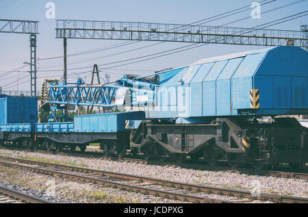 Blue railroad crane on the ways. Stock Photo