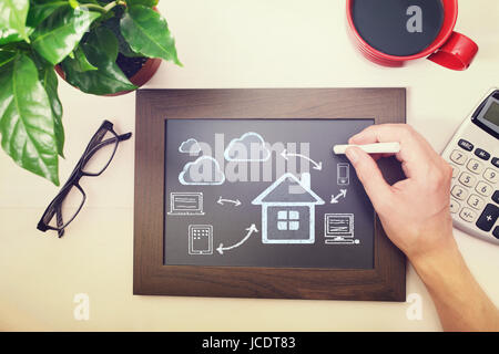 Man drawing cloud connectivity concepts on a blackboard Stock Photo