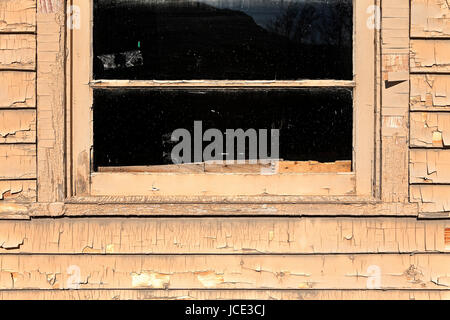 old window and cracking paint on siding details Stock Photo