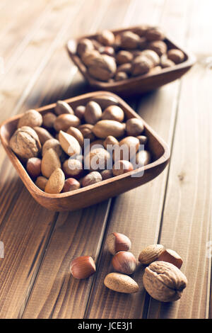 various nuts on wooden table Stock Photo