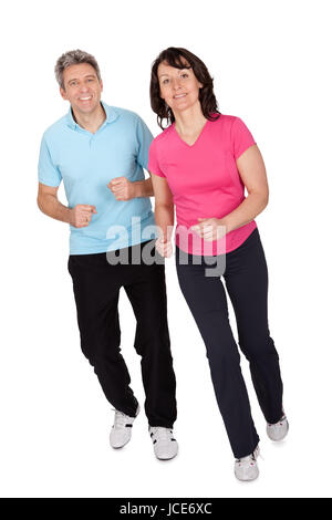 Mature fitness couple running towards camera. Isolated on white Stock Photo