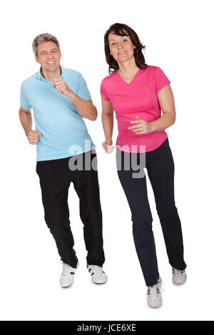 Mature fitness couple running towards camera. Isolated on white Stock Photo