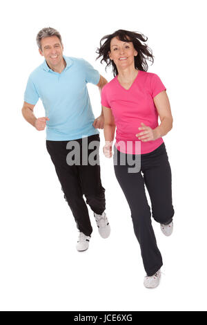 Mature fitness couple running towards camera. Isolated on white Stock Photo