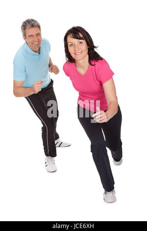 Mature fitness couple running towards camera. Isolated on white Stock Photo