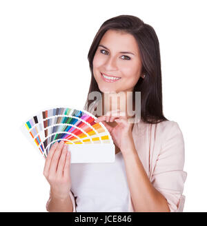 Attractive woman chooses a color scheme. Studio portrait over white Stock Photo