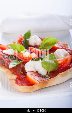 pizza pomodoro, vegetarian and homemade with mozzarella, tomatoes and basil isolated on white background Stock Photo