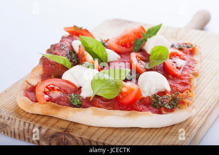 pizza pomodoro, vegetarian and homemade with mozzarella, tomatoes and basil isolated on white background Stock Photo