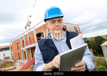Building entrepreneur using digital tablet Stock Photo
