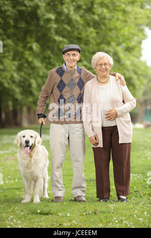 Full length portrait of a senior couple with a dog in the park Stock Photo