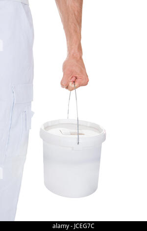 Close-up Of A Painter Holding Bucket Over White Background Stock Photo