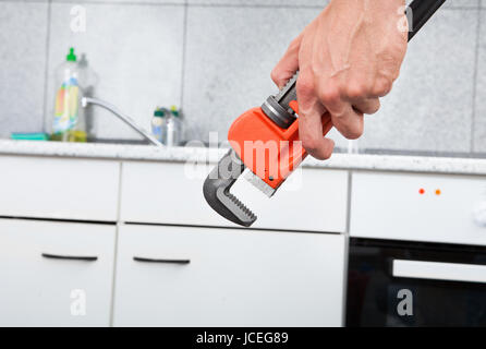 Close-up Of Wrench And Kitchen In Background Stock Photo