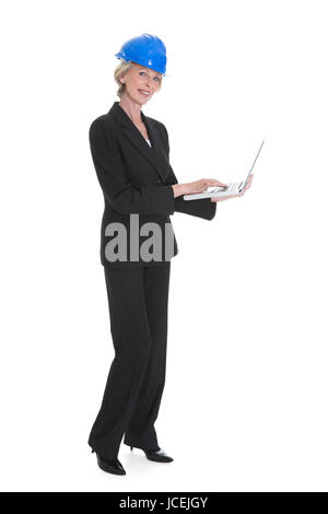 Portrait Of Female Architect Using Laptop On White Background Stock Photo