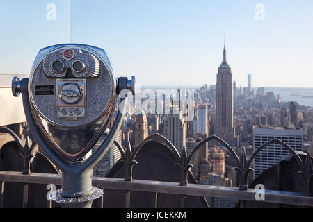 NEW YORK - SEPTEMBER 12: Binoculars on Rockefeller Center with Empire State Building and city view at the end of the day on September 12, 2016 Stock Photo