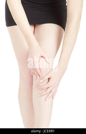 Woman with black dress with knee and legs pain isolated on white, clipping path Stock Photo