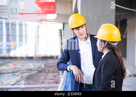 Two smiling architects at construction site Stock Photo
