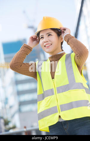 Smiling female construction worker Stock Photo
