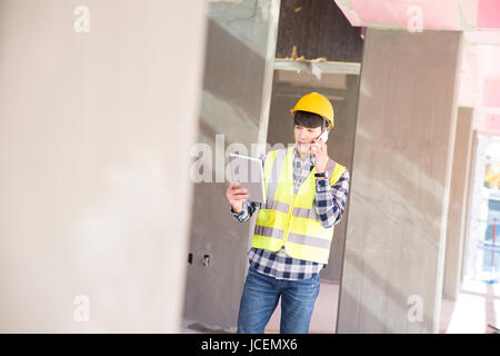 Construction worker talking on cellphone Stock Photo