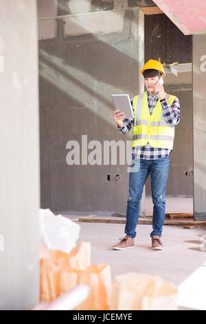 Construction worker talking on cellphone Stock Photo