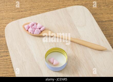 Healthcare Concept, A Wooden Spoon Full with Vitamins Pills on A Plate. Stock Photo