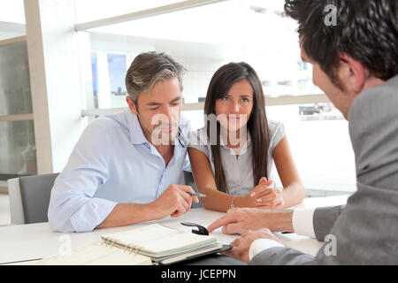 Father and girl signing loan contract Stock Photo