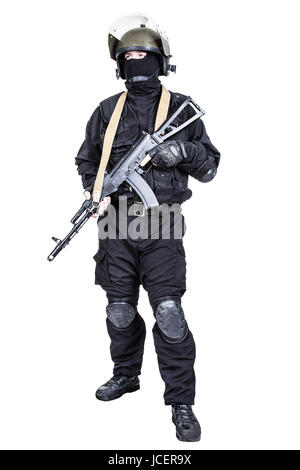 Spec ops soldier in black uniform and face mask with his rifle Stock Photo