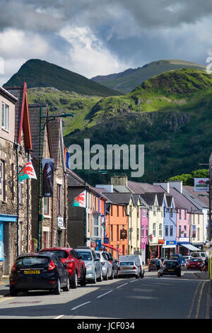 Colourful Llanberis High Street backed by Mount Snowdon, Snowdonia National Park, North Wales, UK Stock Photo