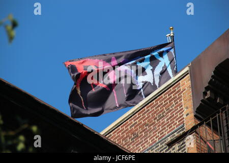 New York, USA. 14th June, 2017. At the East Village a flag of the artist Marilyn Minter which shows large, colourful letters 'RESIST' in New York, USA, 14 June 2017. Photo: Christina Horsten/dpa/Alamy Live News Stock Photo