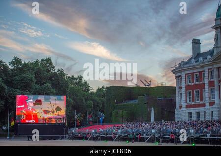 Horse Guards Parade, London UK. 15th June 2017. 2017 marks the 100th anniversary of Passchendaele, one of the bloodiest conflicts of the First World War. A new composition is performed, written by Major Simon Haw, Director of Music Coldsteam Guards Band at Beating Retreat, the words taken from Colour Sergeant Darren Hardy’s poem, 'Tyne Cot Passchendaele' which was written after a Battlefield Tour in 2013. The performance coincides with a dramatic sunset over central London. Credit: Malcolm Park / Alamy Live News. Stock Photo