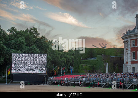 Horse Guards Parade, London UK. 15th June 2017. 2017 marks the 100th anniversary of Passchendaele, one of the bloodiest conflicts of the First World War. A new composition is performed, written by Major Simon Haw, Director of Music Coldsteam Guards Band at Beating Retreat, the words taken from Colour Sergeant Darren Hardy’s poem, 'Tyne Cot Passchendaele' which was written after a Battlefield Tour in 2013. The performance coincides with a dramatic sunset over central London. Credit: Malcolm Park / Alamy Live News. Stock Photo