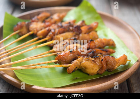 Close up Malaysian chicken satay on wooden dining table, one of famous local dishes. Stock Photo