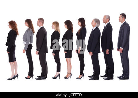 Long line of diverse professional business people standing in a queue in profile isolated on white Stock Photo