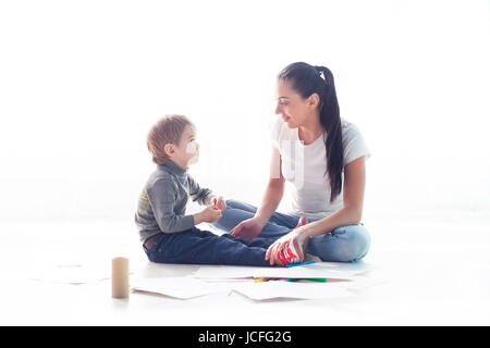 mother and young son painted pencils learn to draw Stock Photo