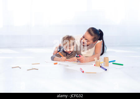 mother and young son painted pencils learn to draw Stock Photo