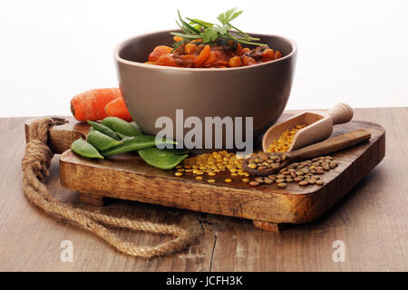 Lentil with carrot and potato in a wooden bowl. Healthy lifestyle. Stock Photo