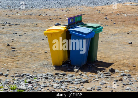 Color coded wheelie bins for recyling on a beach in Playa Las Americas in Teneriffe Stock Photo