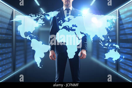 businessman with world map projection in corridor Stock Photo