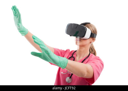 Female nurse wearing virtual reality goggles gesturing  isolated on white background Stock Photo
