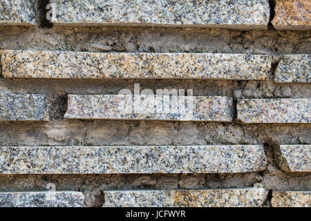 Granite stripes and concrete wall background, texture. Stock Photo