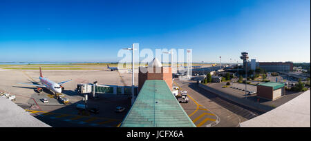 VENICE, ITALY - JUNE 09: Full panoramic view of planes parked at the passenger terminal of Marco Polo Airport, Venice on June 09, 2014. The airport is popular with tourists to the region. Stock Photo
