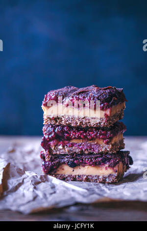 Stack of raw peanut butter and raspberry chia jam bars Stock Photo