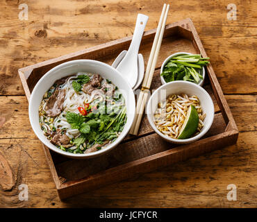 Pho Bo vietnamese Soup with beef and Soybean seedlings in wooden tray on wooden background Stock Photo