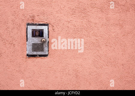Closeup shot of a intercom on a red wall Stock Photo