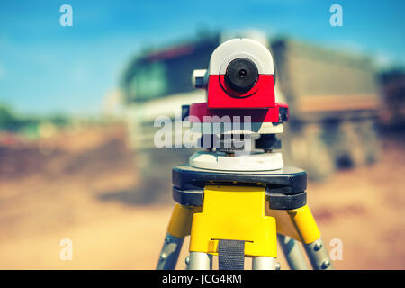 Surveying measuring equipment level theodolite on tripod at construction site Stock Photo