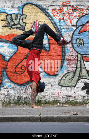 A performing HipHop Dancer in front of a Graffiti wall. Stock Photo