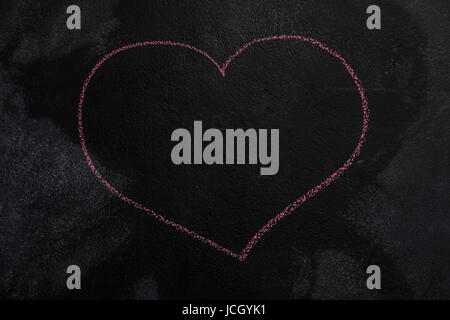 Red empty heart shape drawn with chalk on blackboard Stock Photo